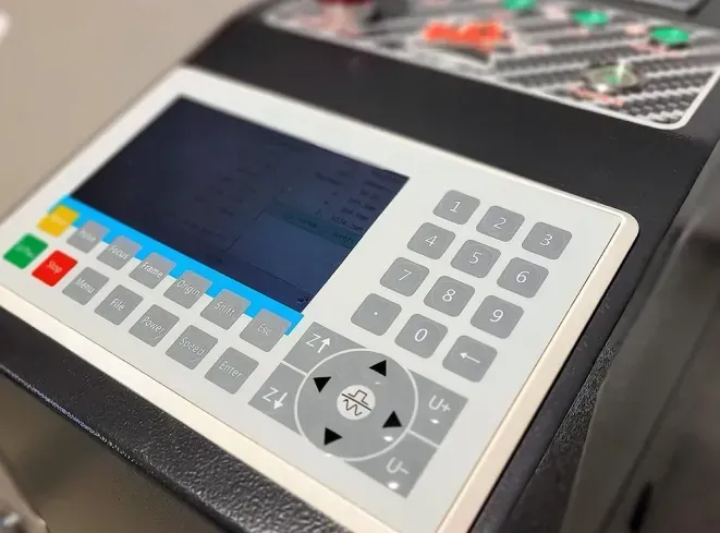 Control panel with buttons, numeric keypad, and a screen; likely for operating machinery.