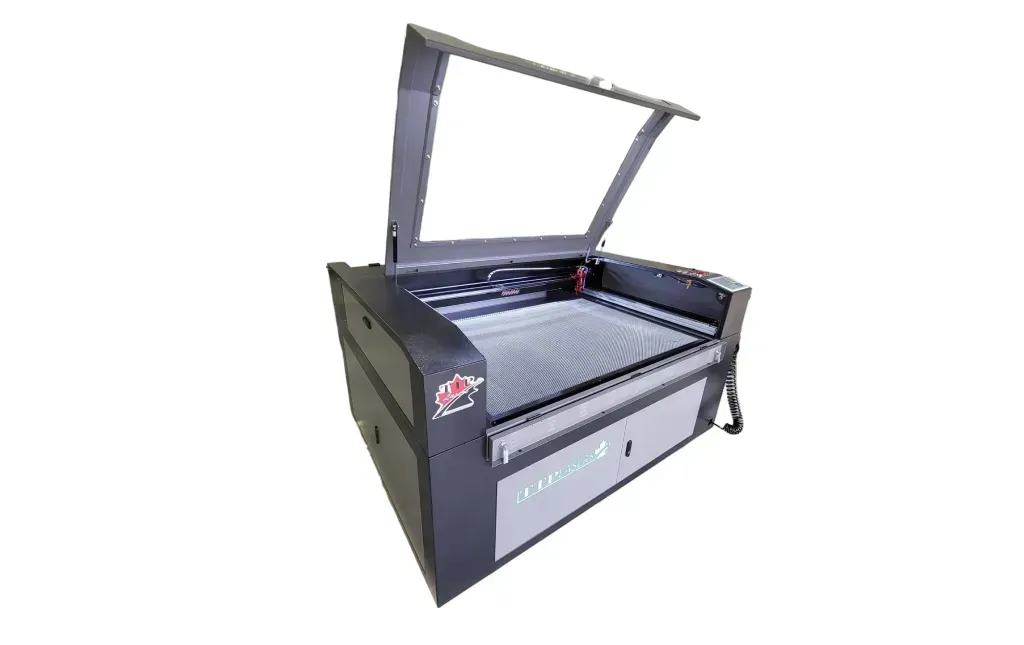 Laser cutter with open lid, gray and black, industrial setting.
