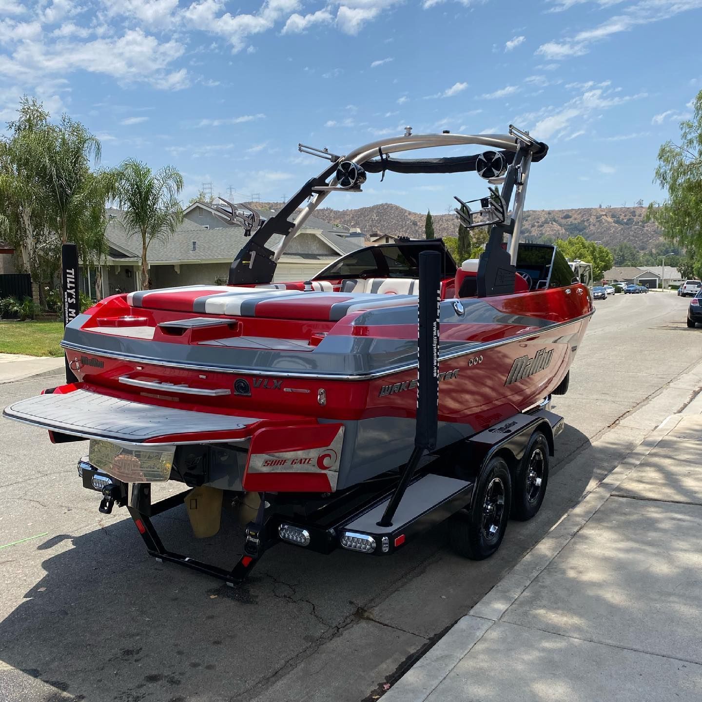 A red boat is parked on the side of the road