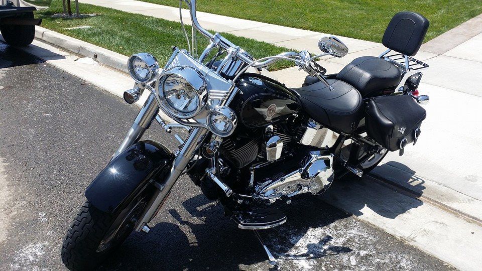 A black motorcycle is parked on the side of the road.