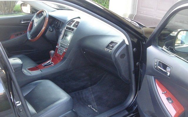 The inside of a black car with the door open