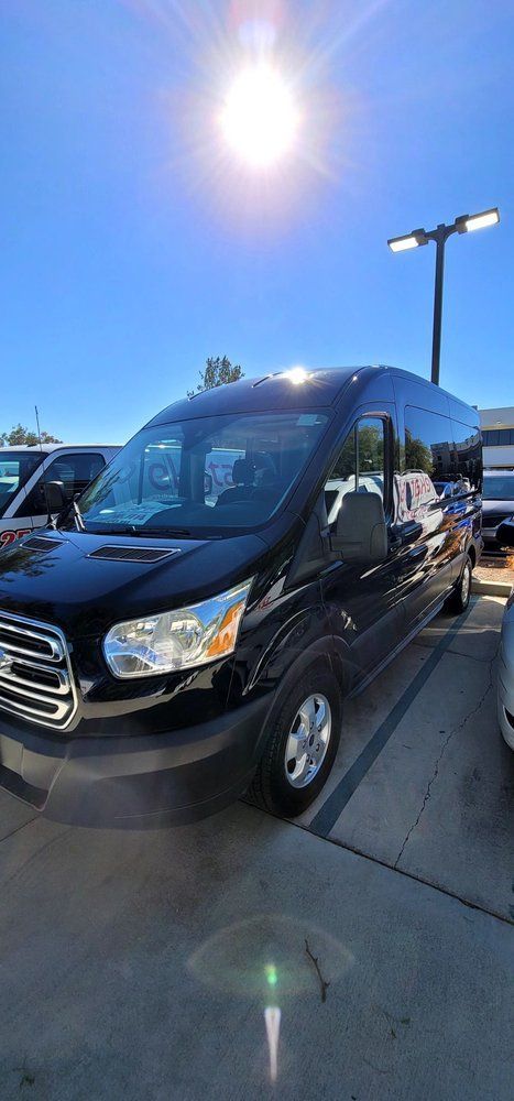 A black van is parked in a parking lot.