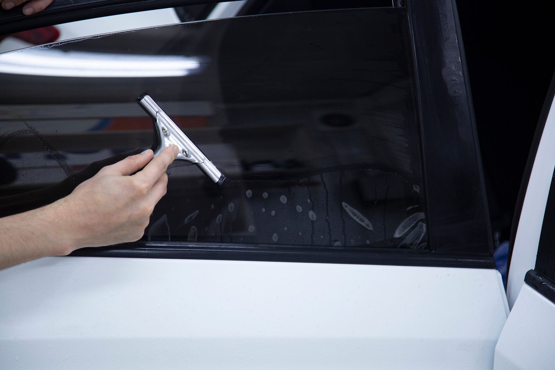 A person is cleaning the seats of a car with a cloth.