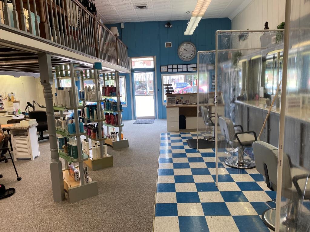 A salon with a checkered floor and a clock on the wall
