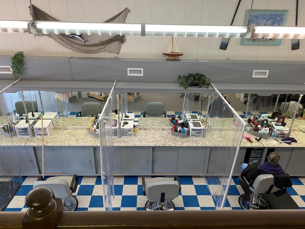 An aerial view of a barber shop with a checkered floor