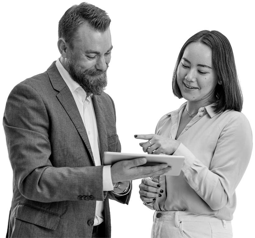 A man and a woman are looking at a tablet together.