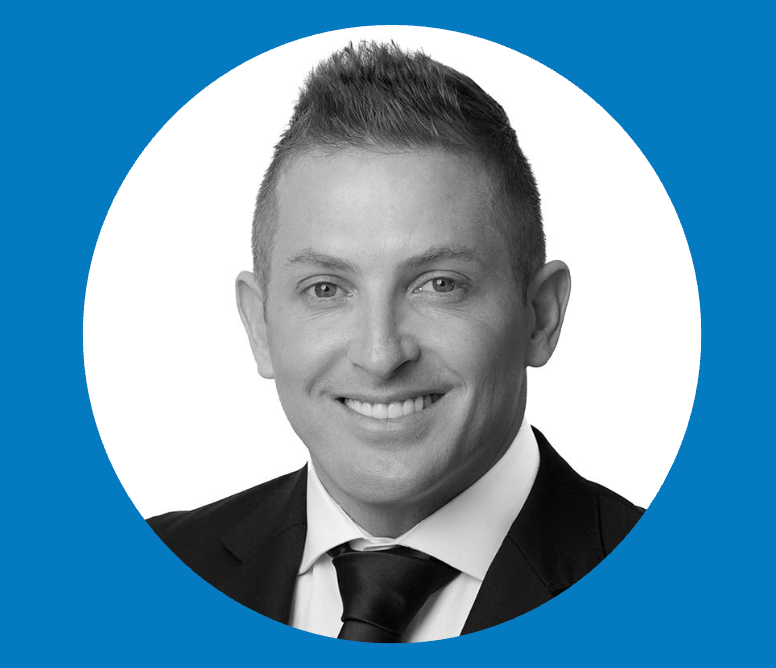 A man in a suit and tie is smiling in a blue circle