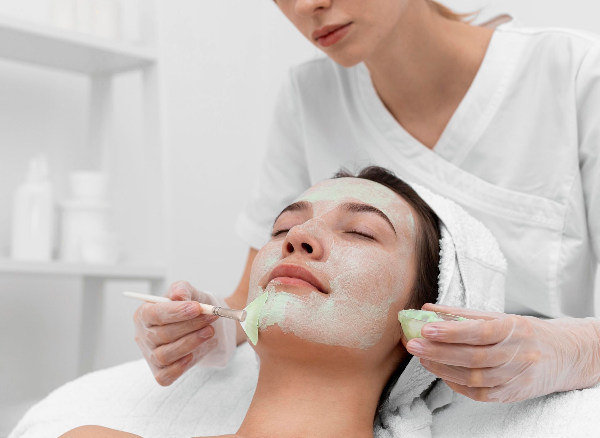 A woman is getting a facial treatment at a spa.