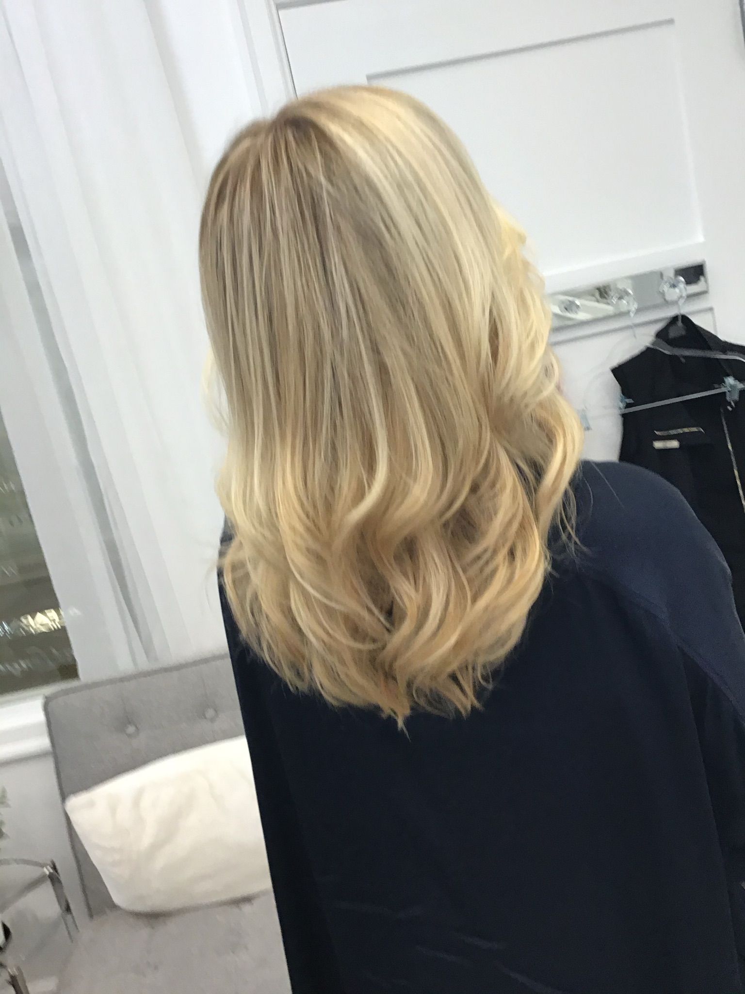 A woman with blonde hair is wearing a black shirt.