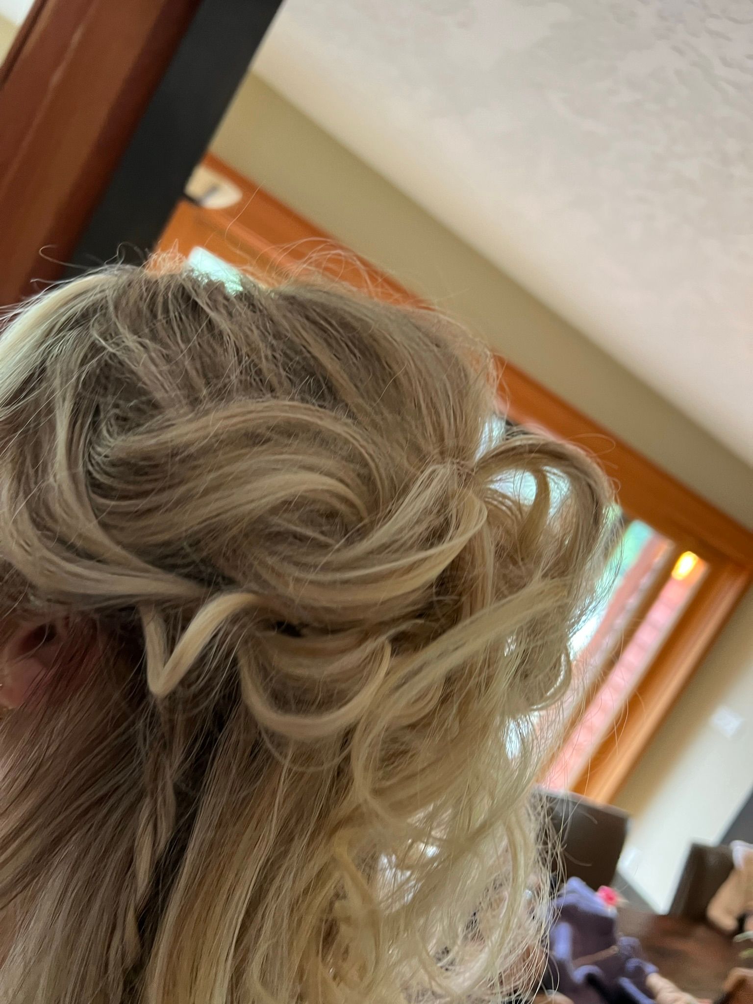 A close up of a woman 's hair in a bun.
