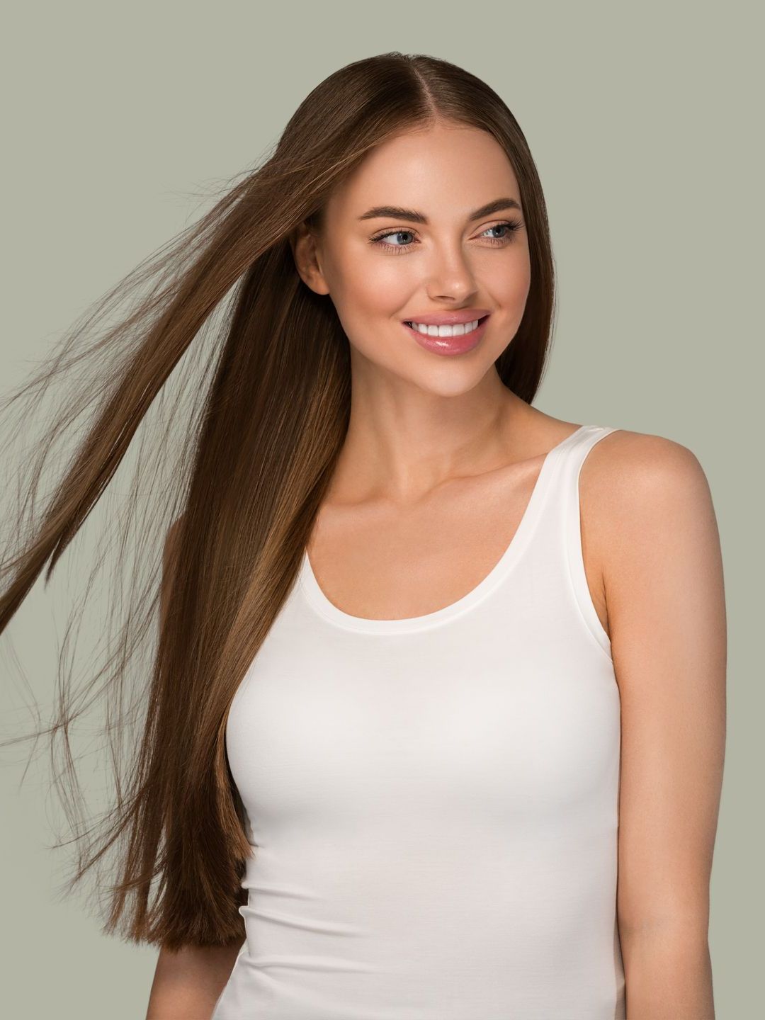 a woman smiling and her hair flying