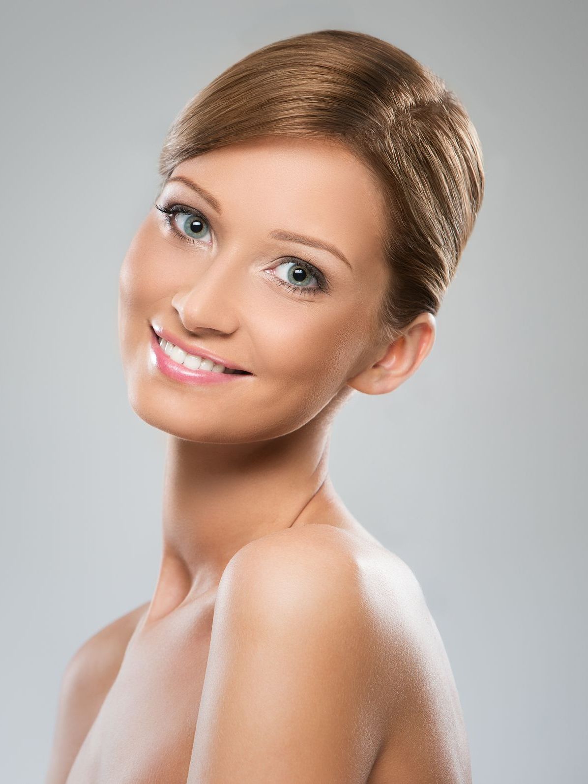 A close up of a woman 's face with a smile on her face.