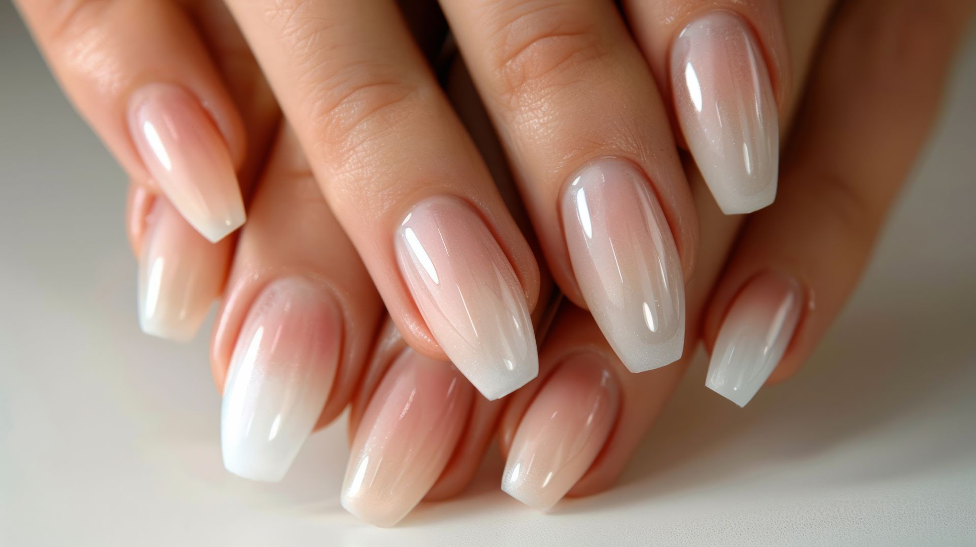 A close up of a woman 's nails with long acrylic nails.