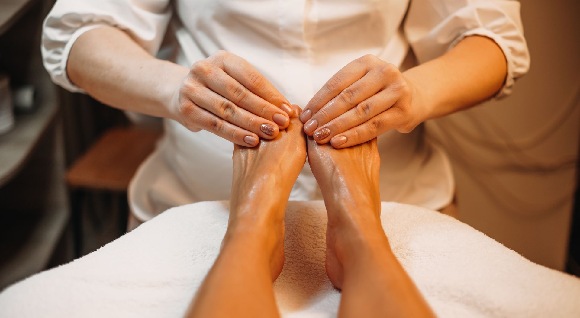 A woman is getting a foot massage at a spa.