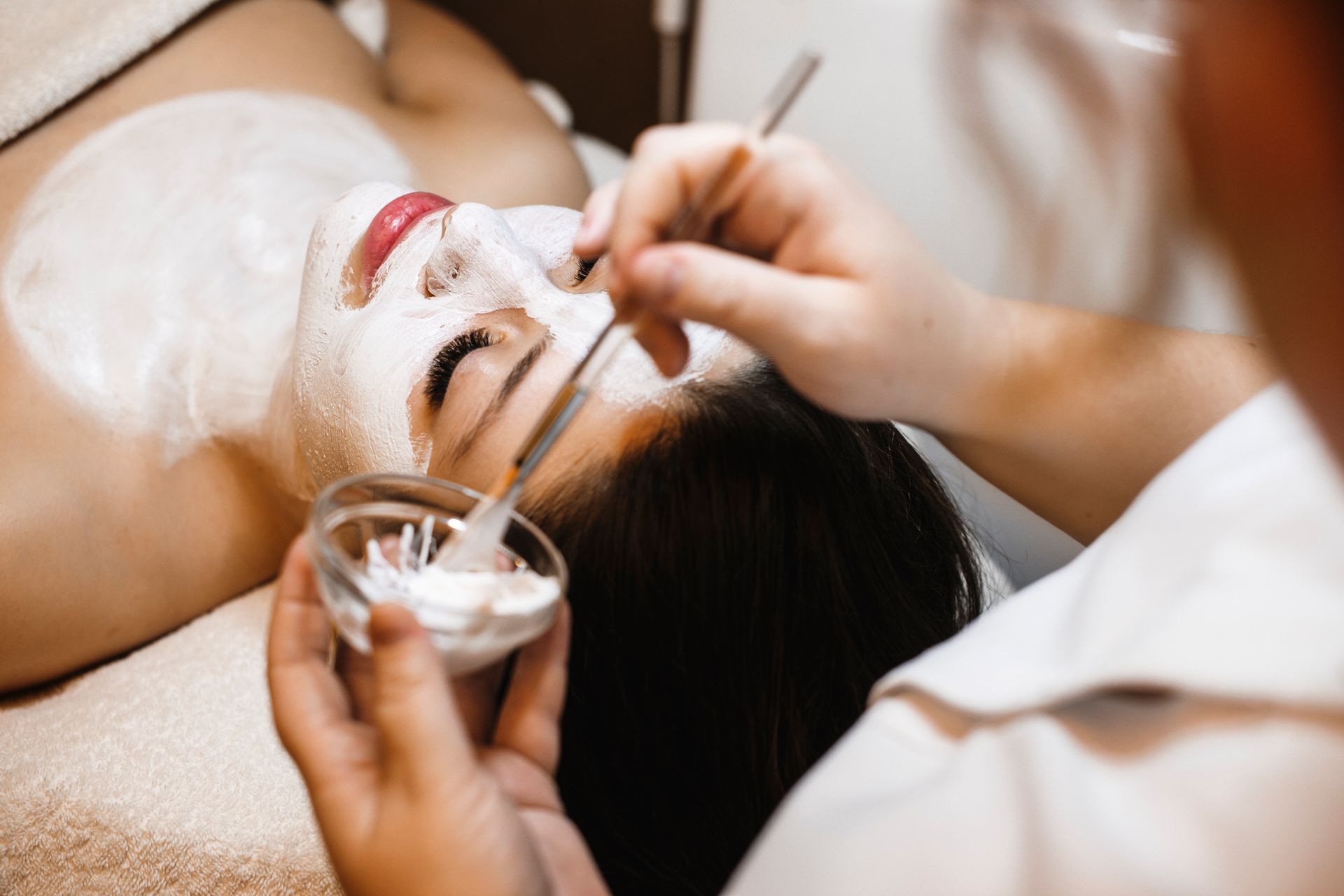 A woman is getting a facial treatment at a spa.