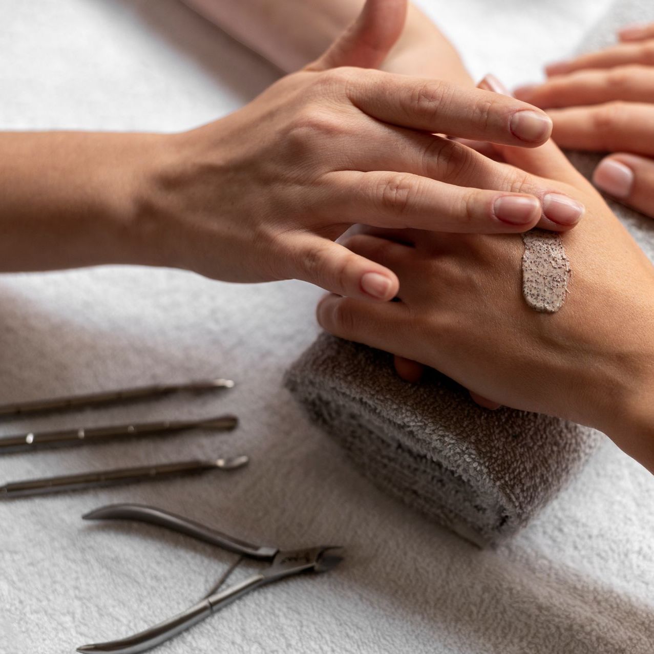 A woman is getting her nails done at a nail salon.