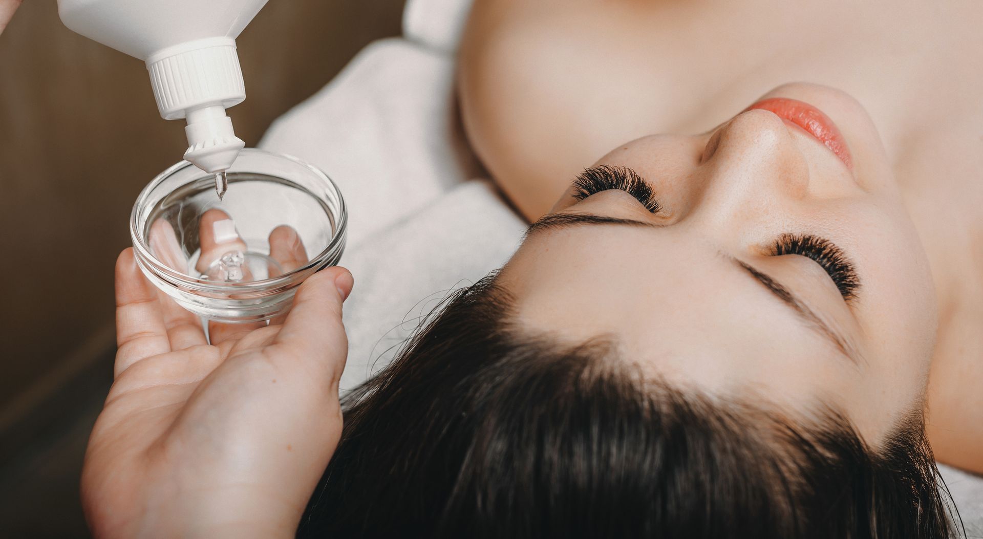 A woman is getting a facial treatment at a spa.