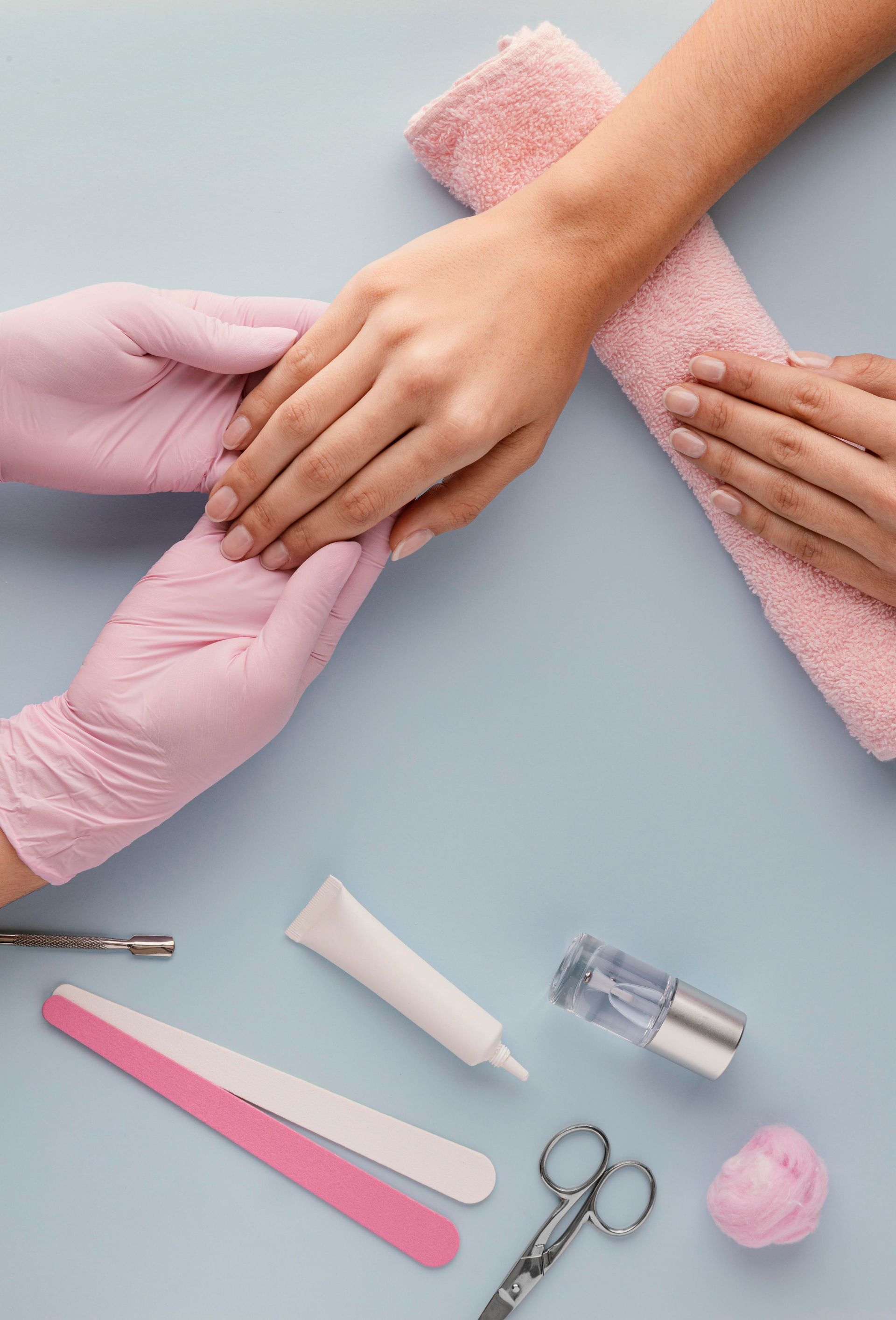 A woman is getting a manicure at a nail salon.