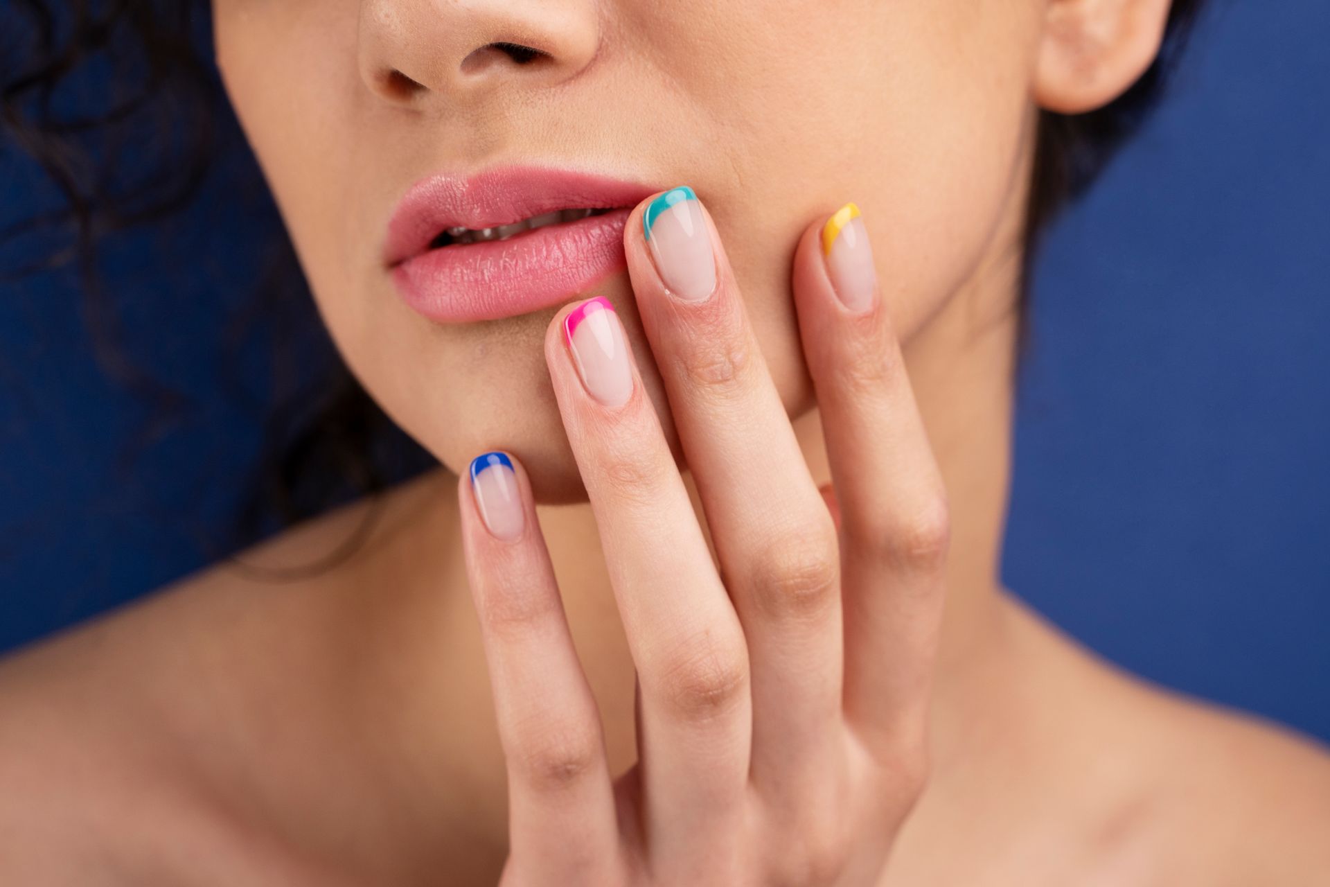 A close up of a person 's nails with a pumpkin face painted on them