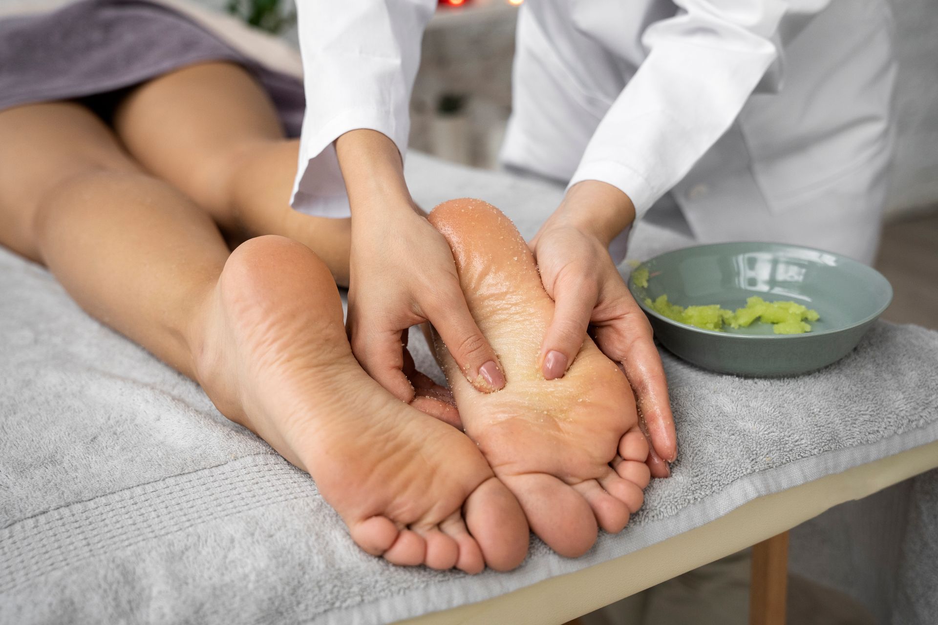 A woman is getting a foot massage at a spa.