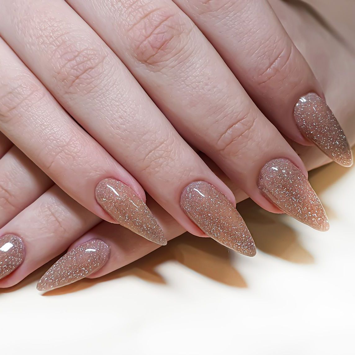 A close up of a woman 's hands with long nails.