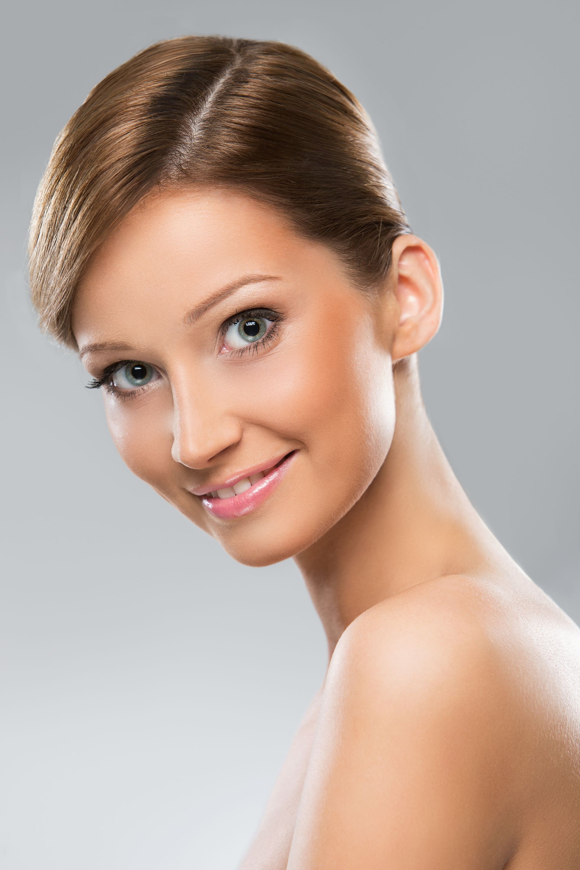 A close up of a woman 's face with a smile on her face.