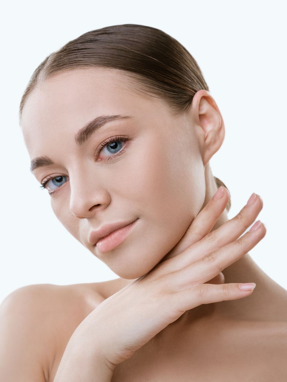 A close up of a woman 's face with her hand on her chin.