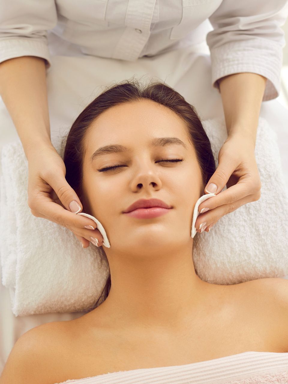 A woman is getting a facial treatment at a spa.