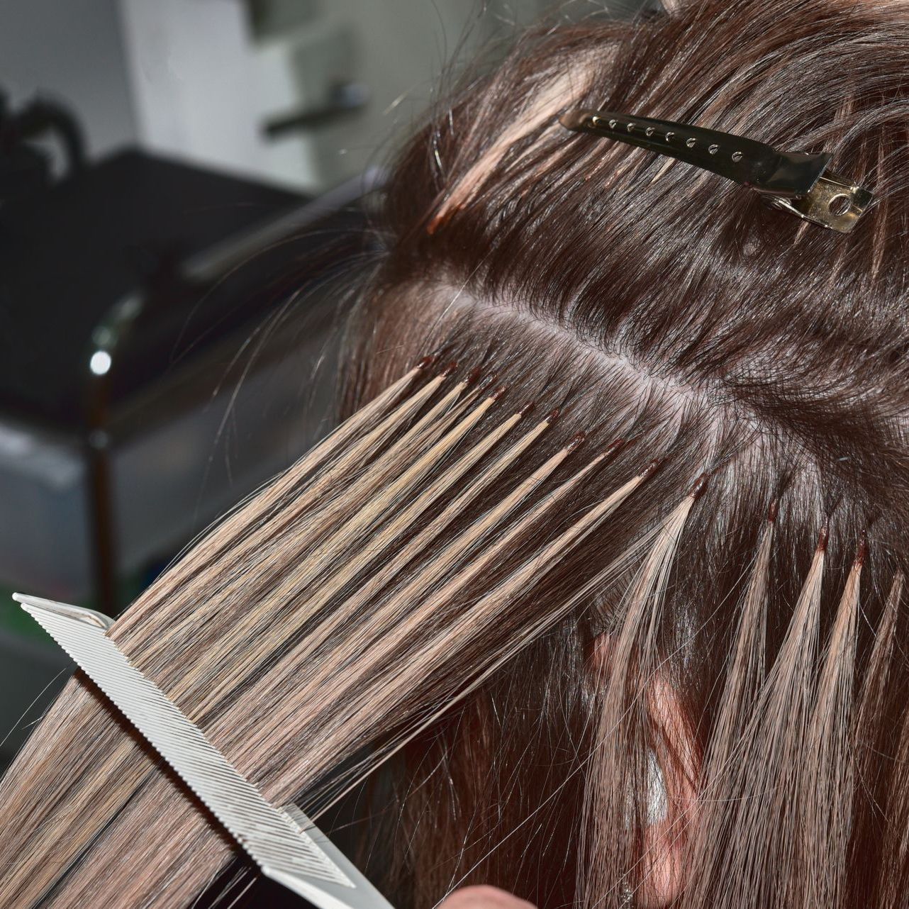 A woman is getting her hair cut by a hairdresser