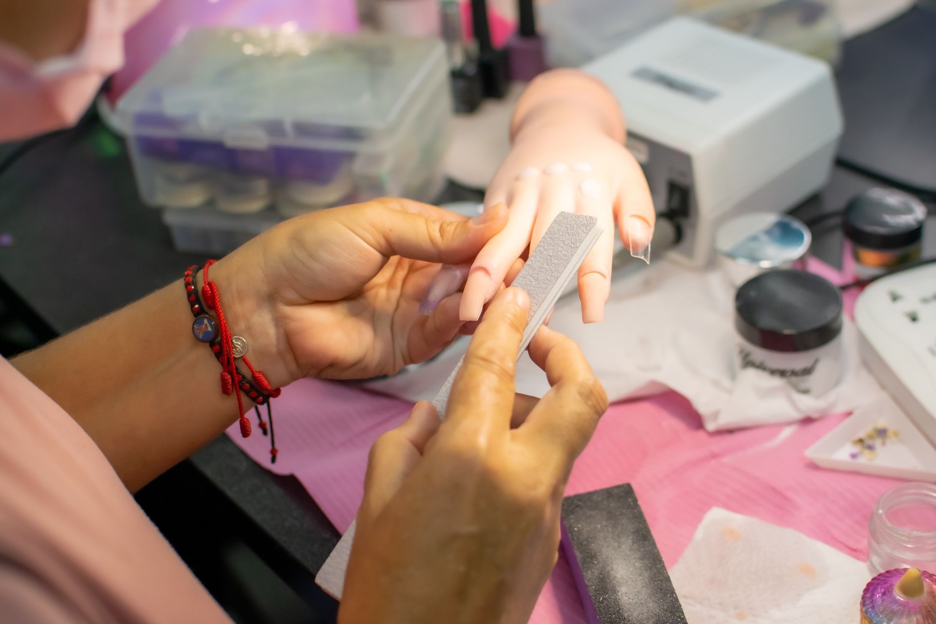 A woman is getting her nails done at a nail salon.