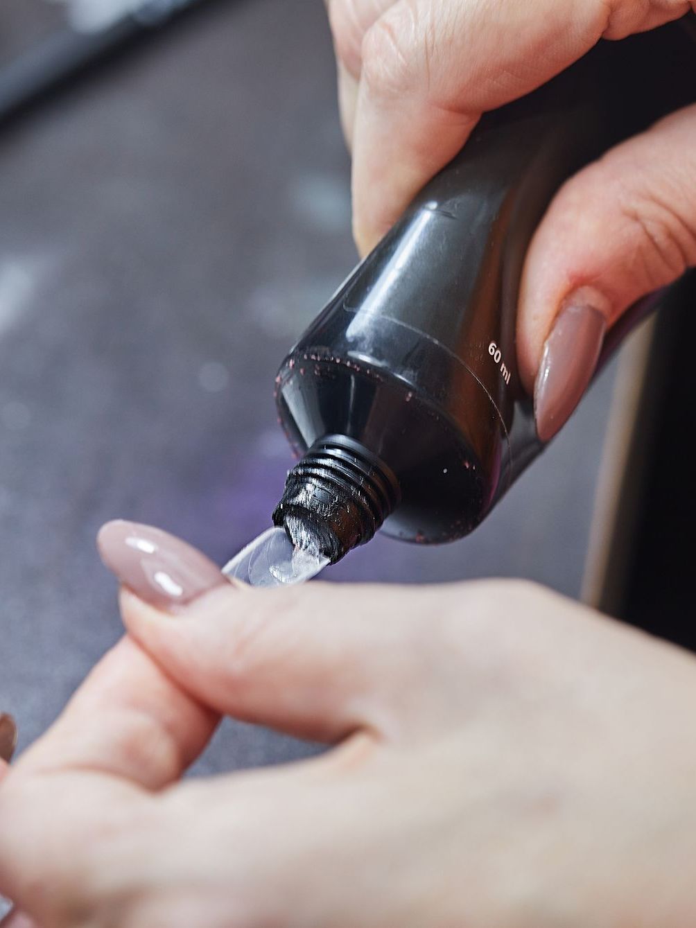 A close up of a person holding a tube of toothpaste