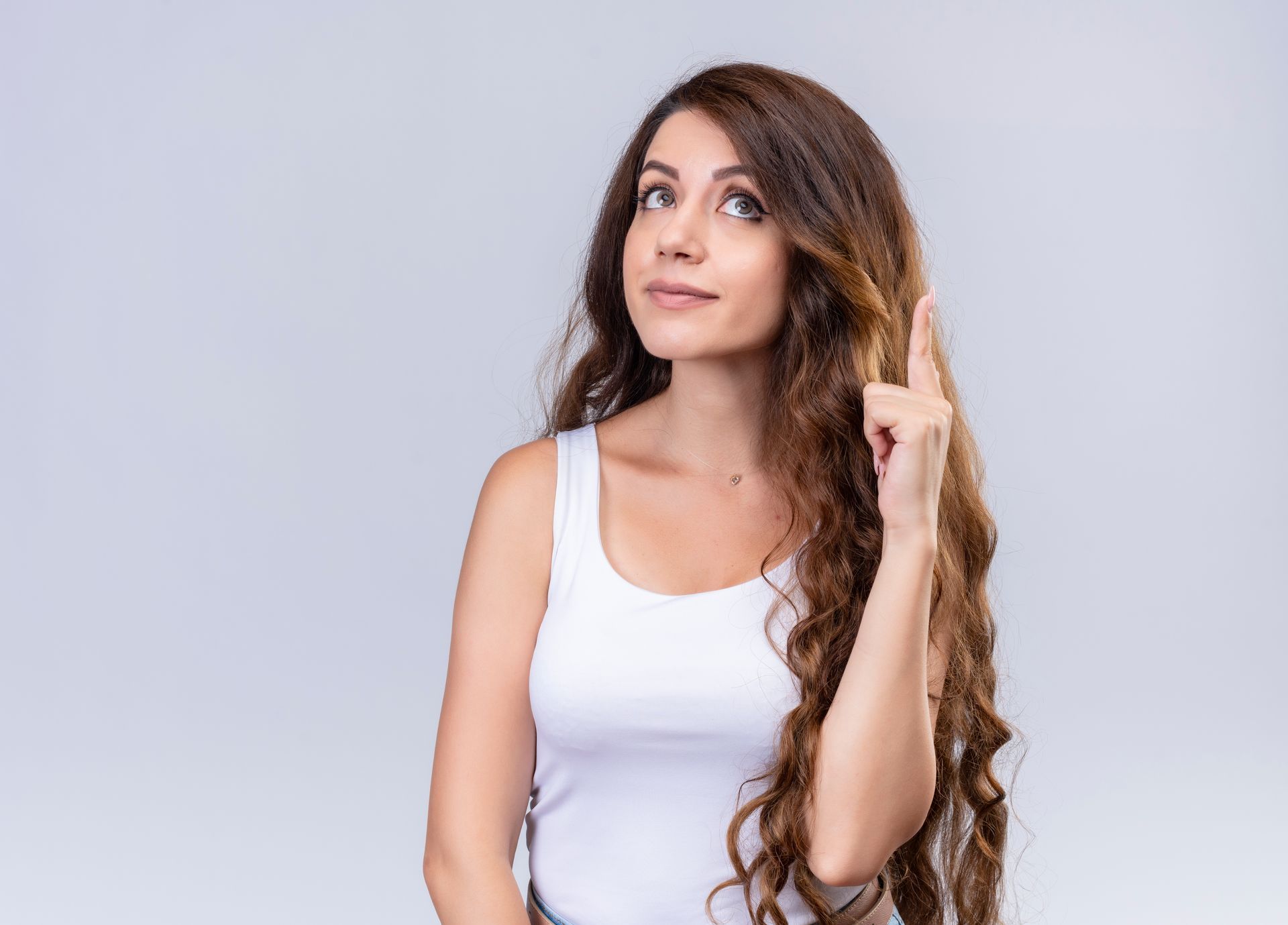 A woman with long hair is pointing up with her finger.