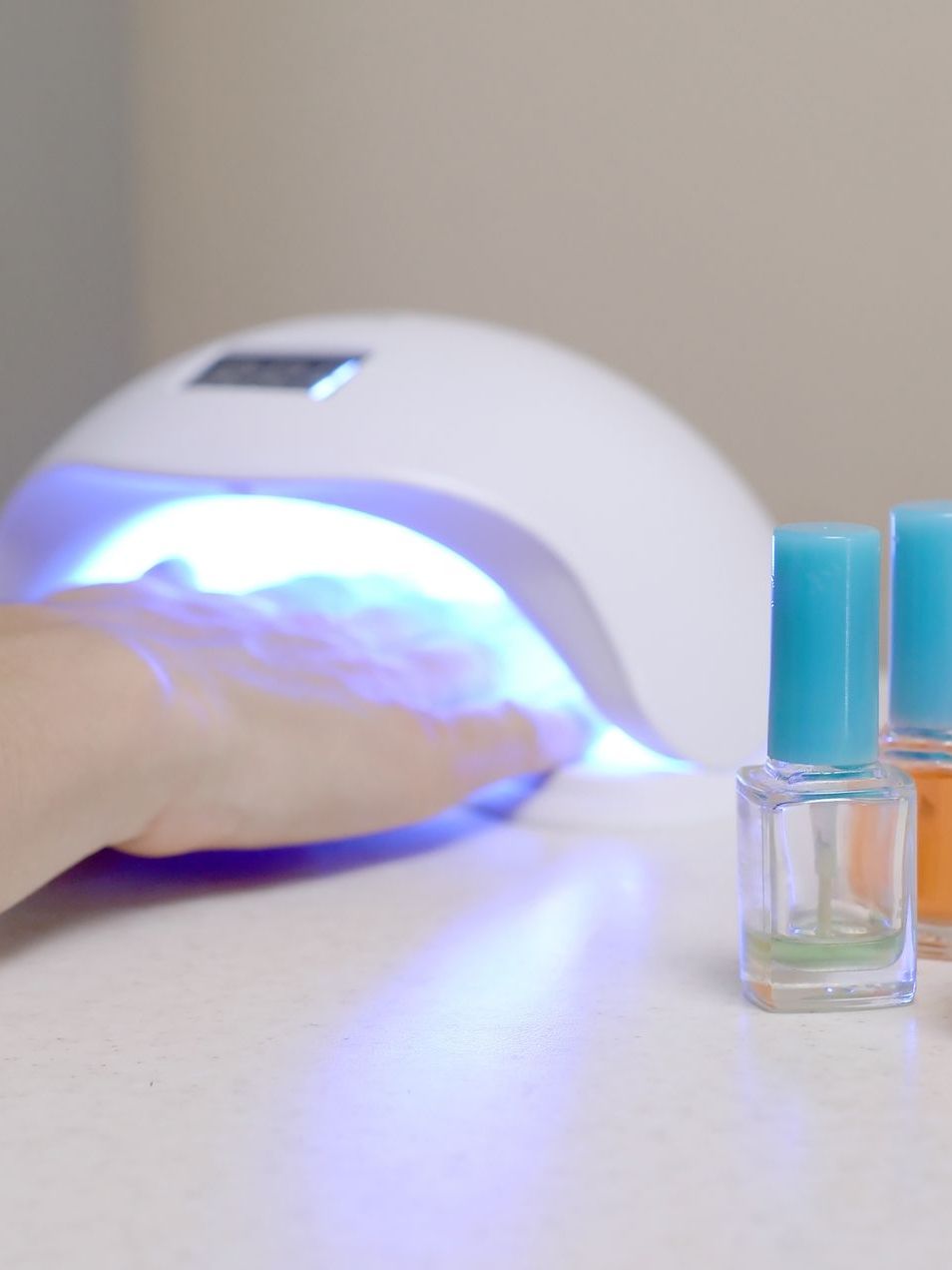 A person is using a nail dryer to dry their nails.