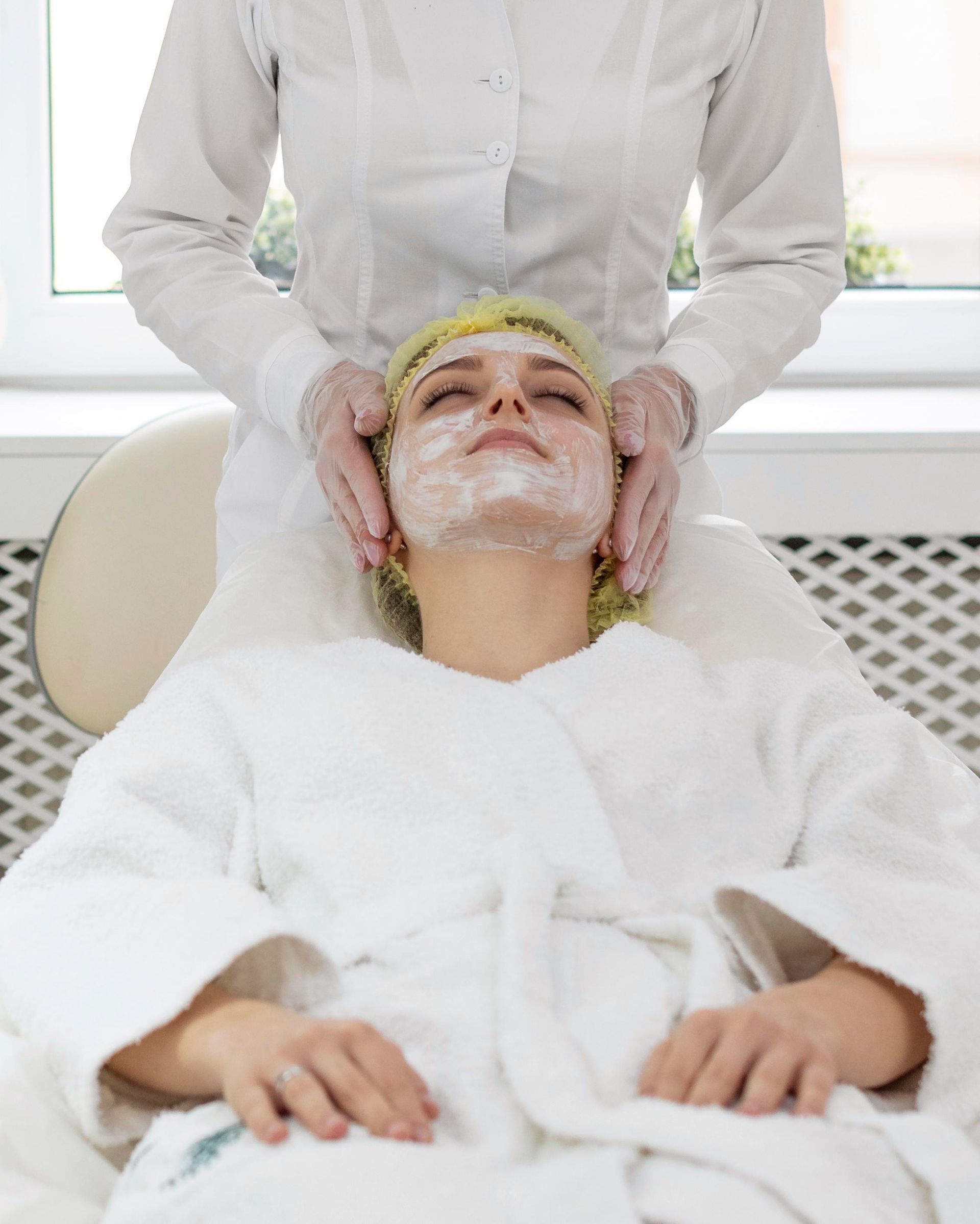 A woman is getting a facial treatment at a spa.