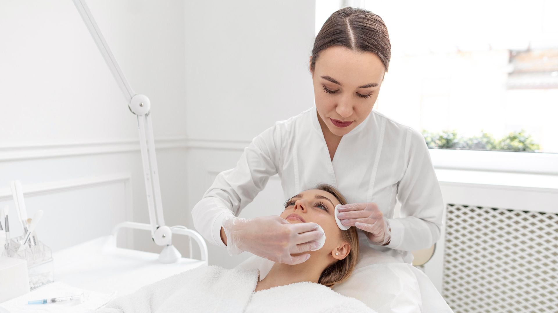 A woman is getting a facial treatment at a beauty salon.