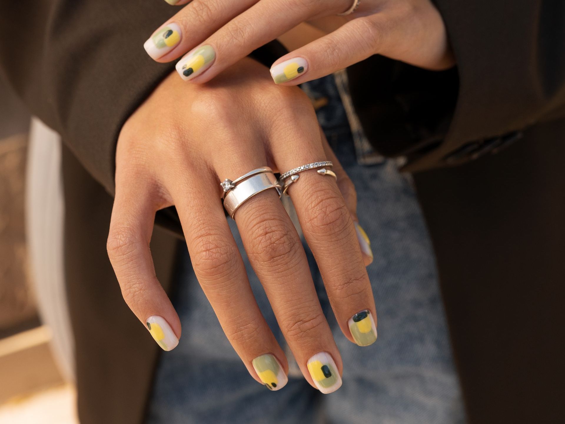 A close up of a woman 's nails with a ring on her finger