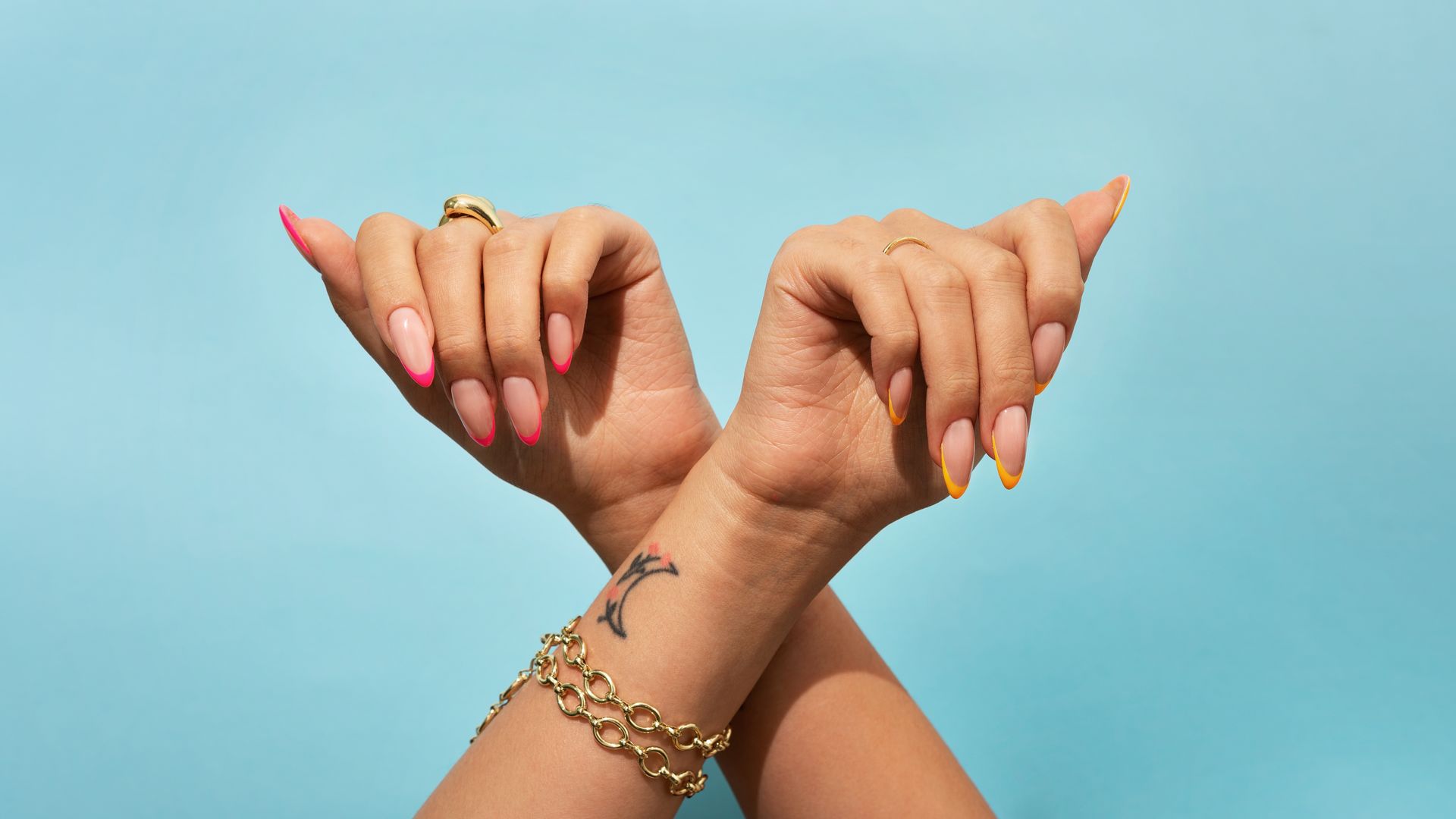 A woman with black nails is covering her mouth with her hand.