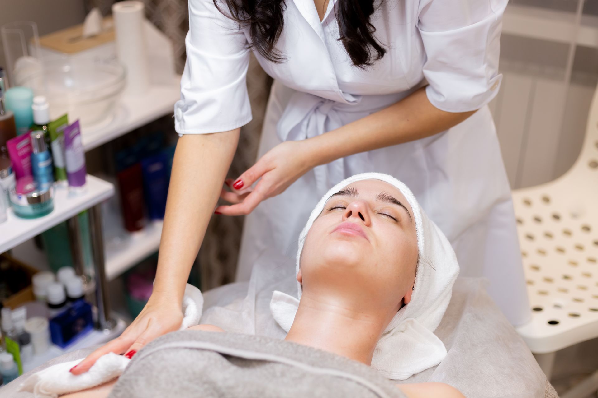 A woman is getting a facial treatment in a beauty salon.