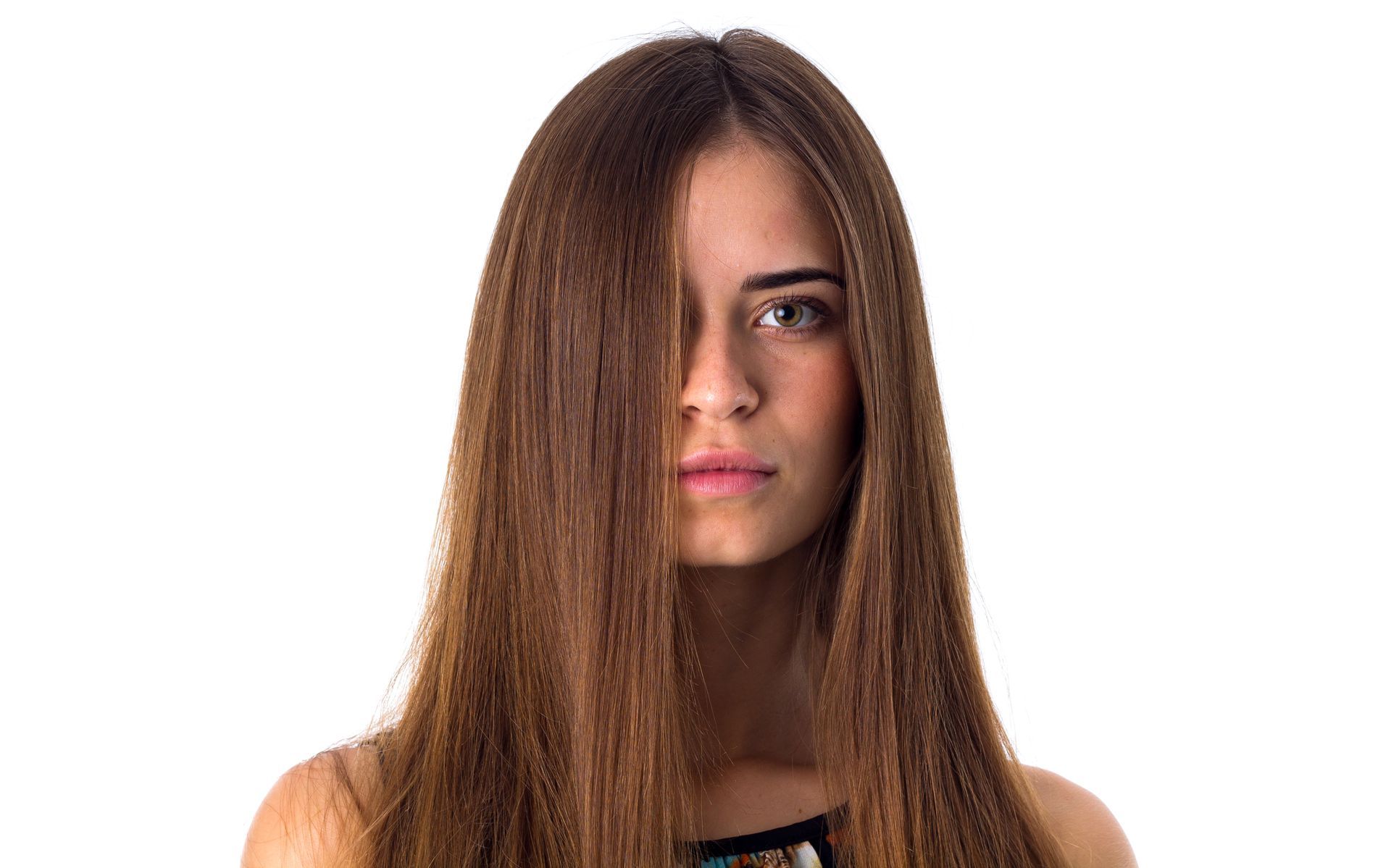 A woman with long hair is covering her face with her hair.