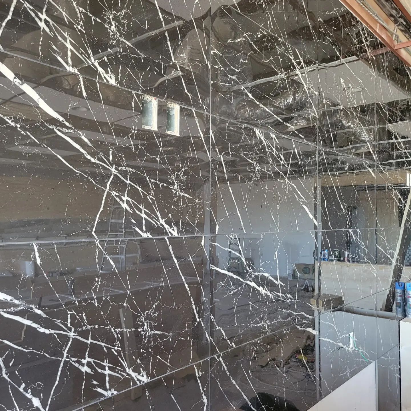 A room with a black and white marble wall