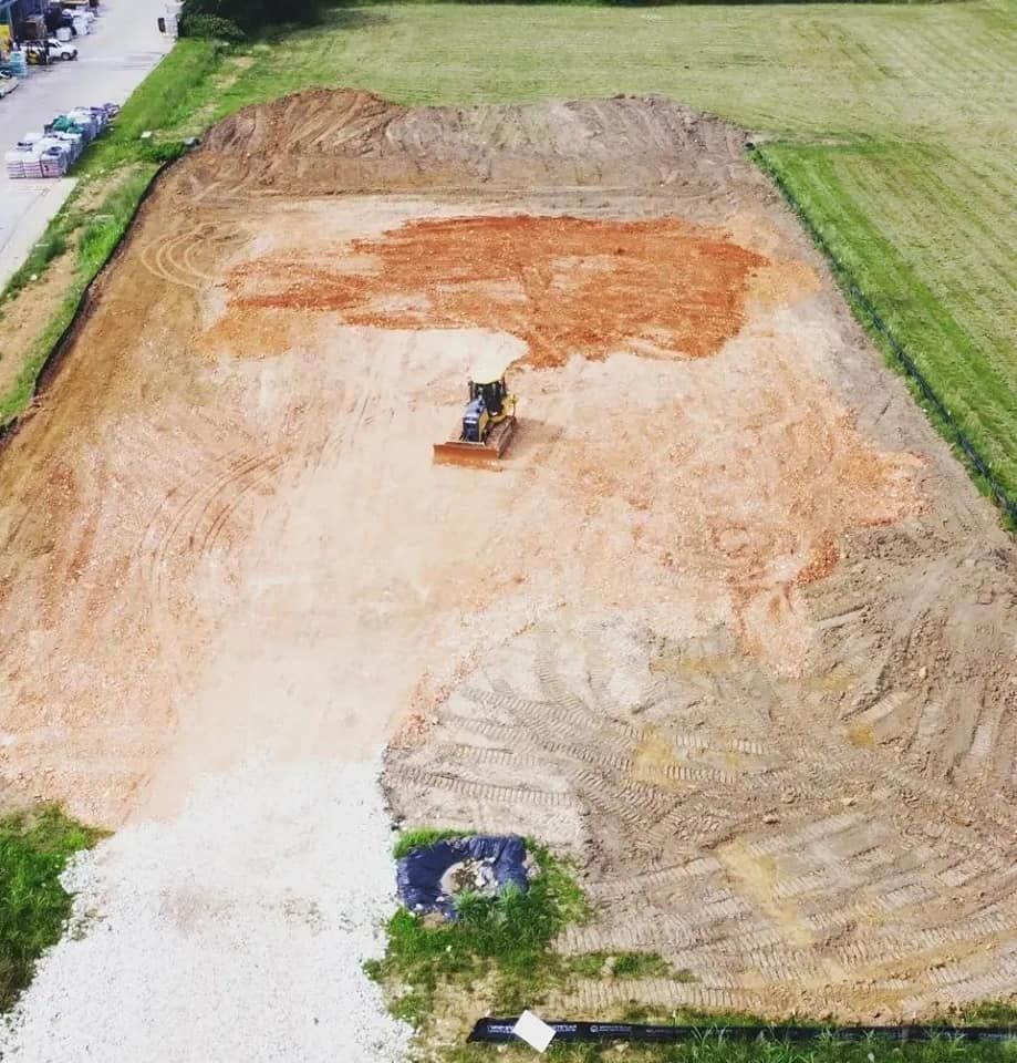 An aerial view of a construction site with a bulldozer in the middle