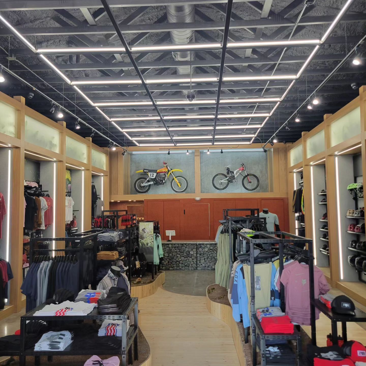 The inside of a clothing store with a motorcycle on the wall