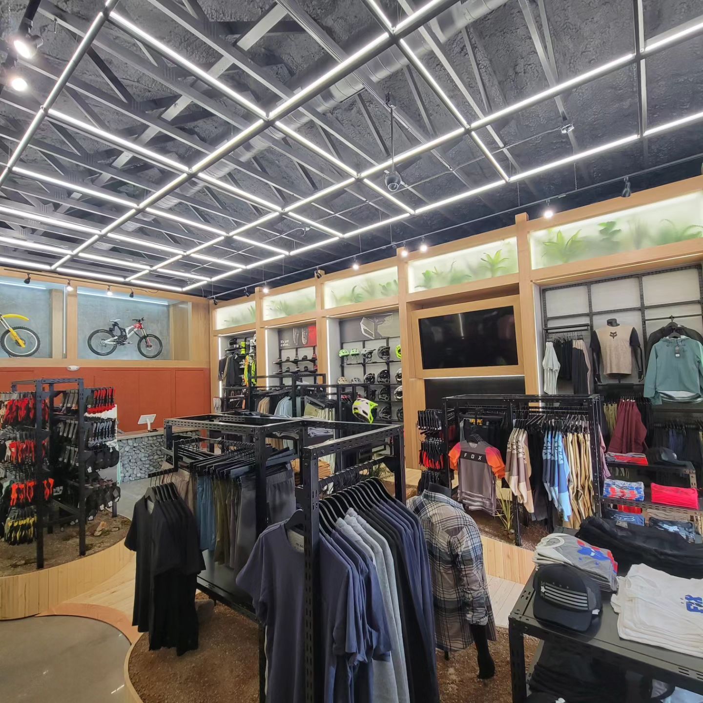 A clothing store with a lot of clothes hanging on racks.