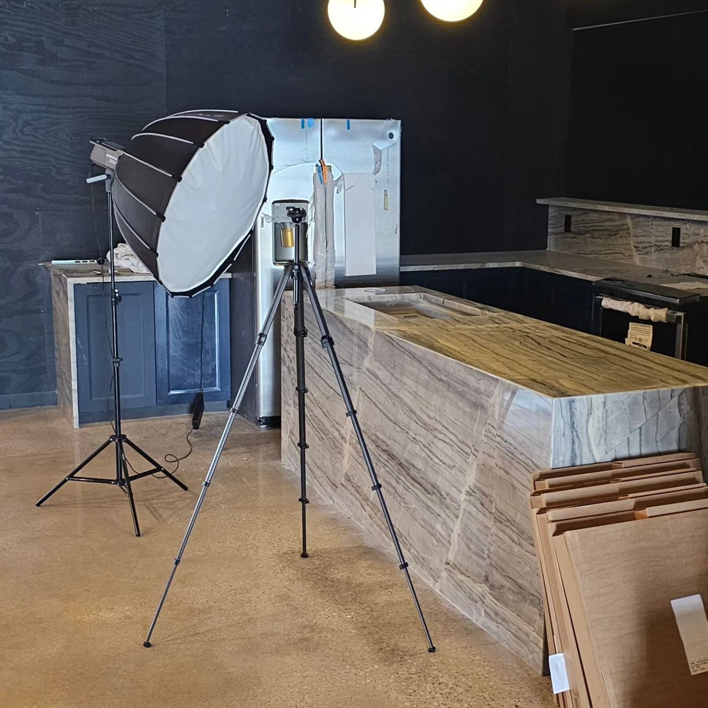 A tripod is sitting in front of a counter in a kitchen