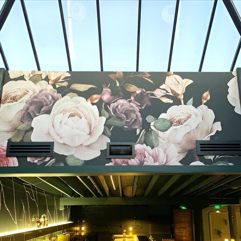 A wall with a picture of flowers on it