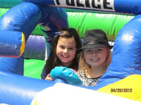 Two Smiling Little Girls in an Inflatable Slide — Columbus, OH — The Venice Club