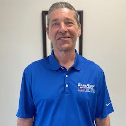 Dan Mastroianni is wearing a blue polo shirt and smiling.