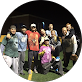 A group of people are posing for a picture in a circle.