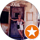 A woman is standing in front of a door with a star in the circle.
