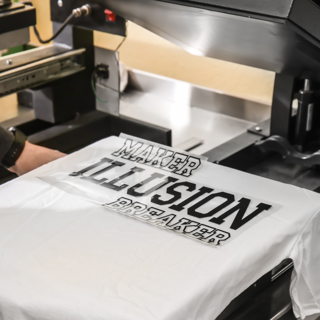 White t-shirt being printed with black 